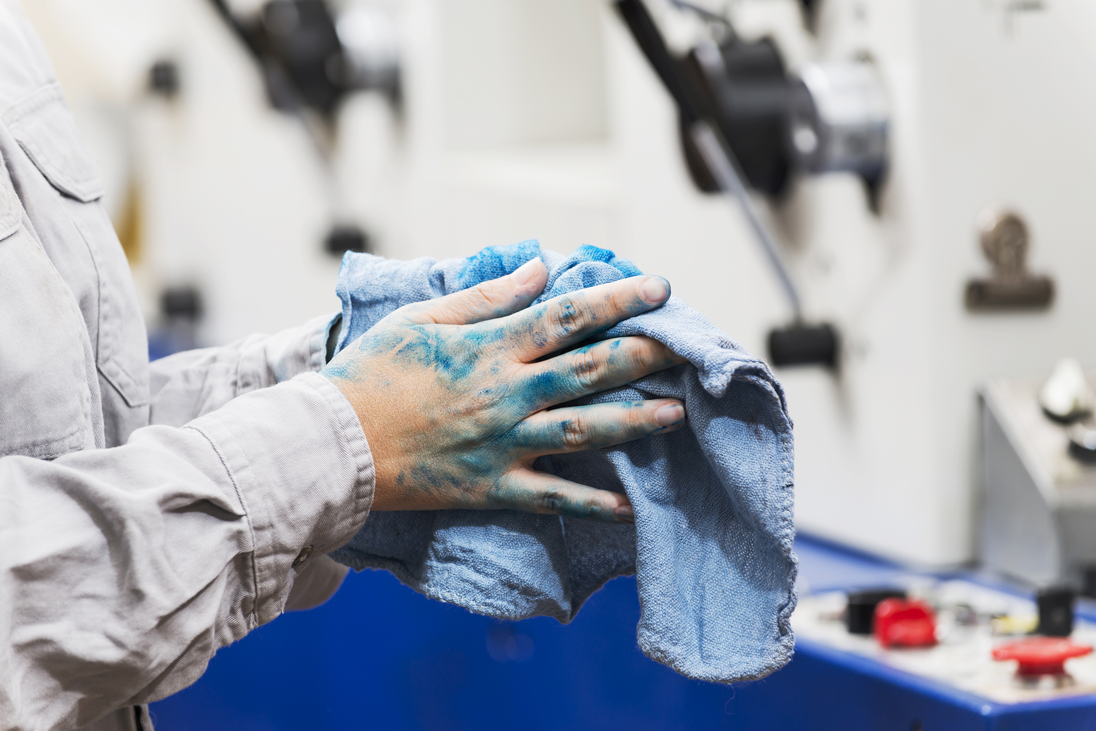 Female worker wiping hands with rag